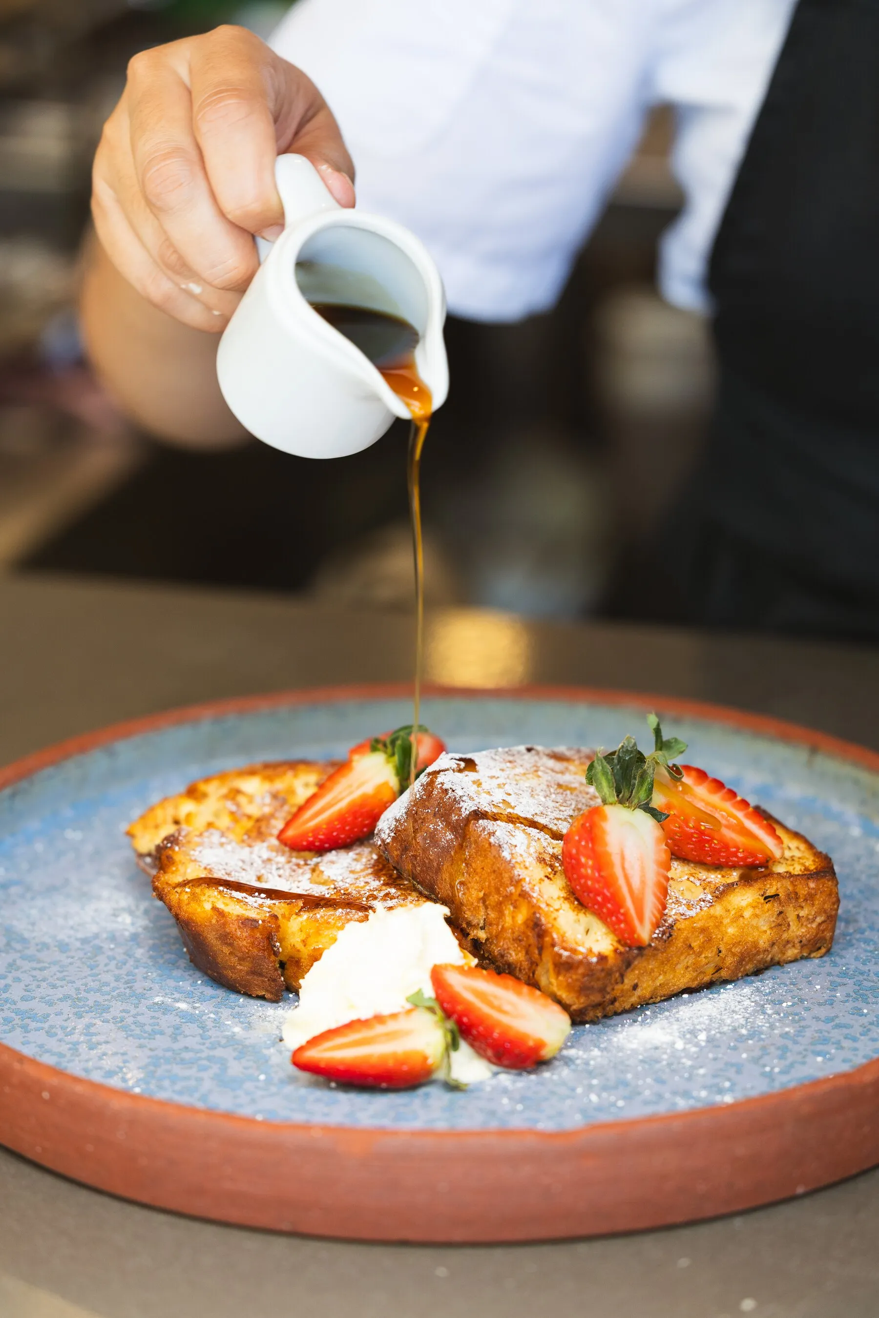 French toast with strawberries and syrup at Manzu