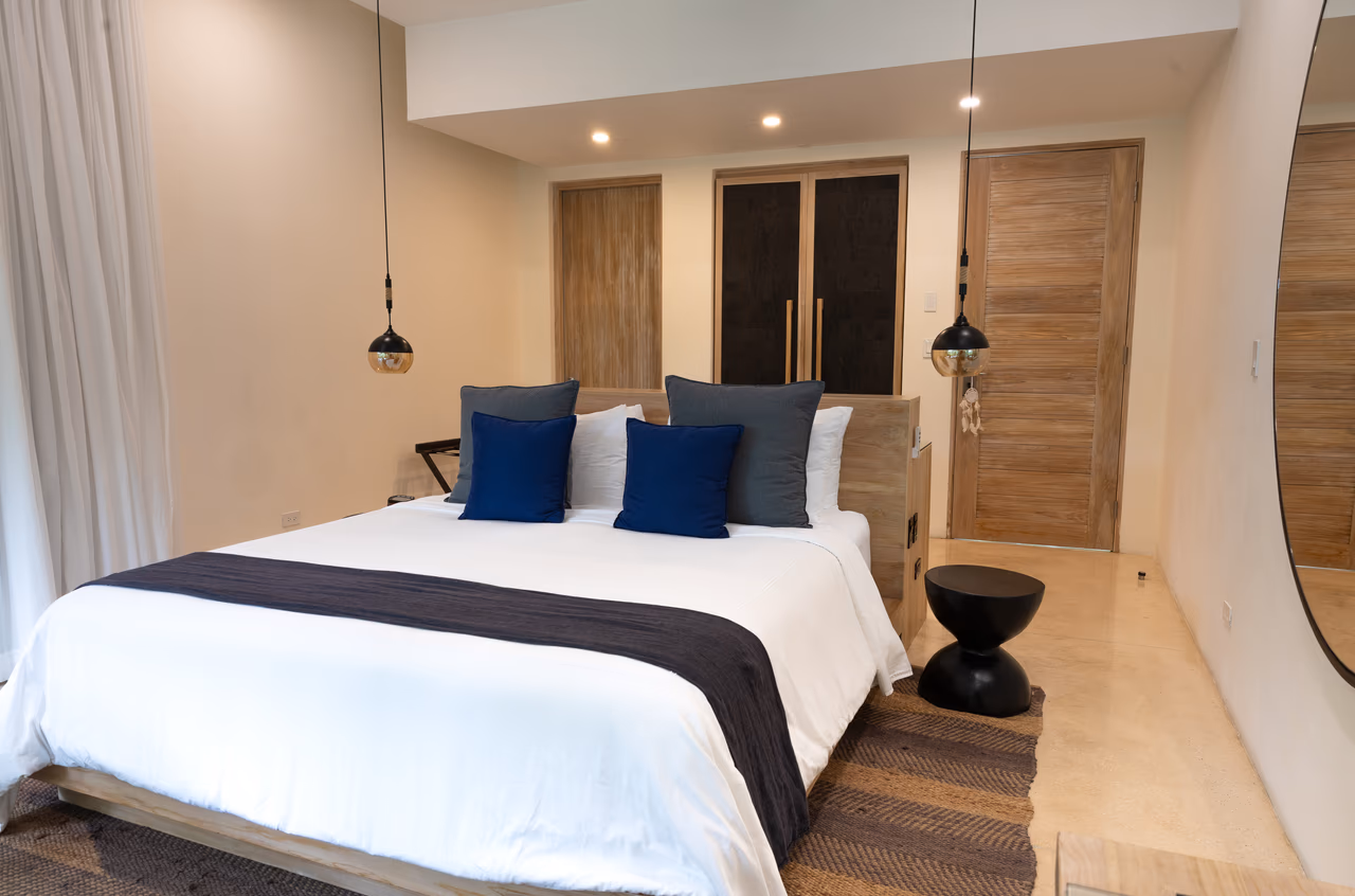 Manti Bungalow king bedroom with warm wood doors and soft lighting