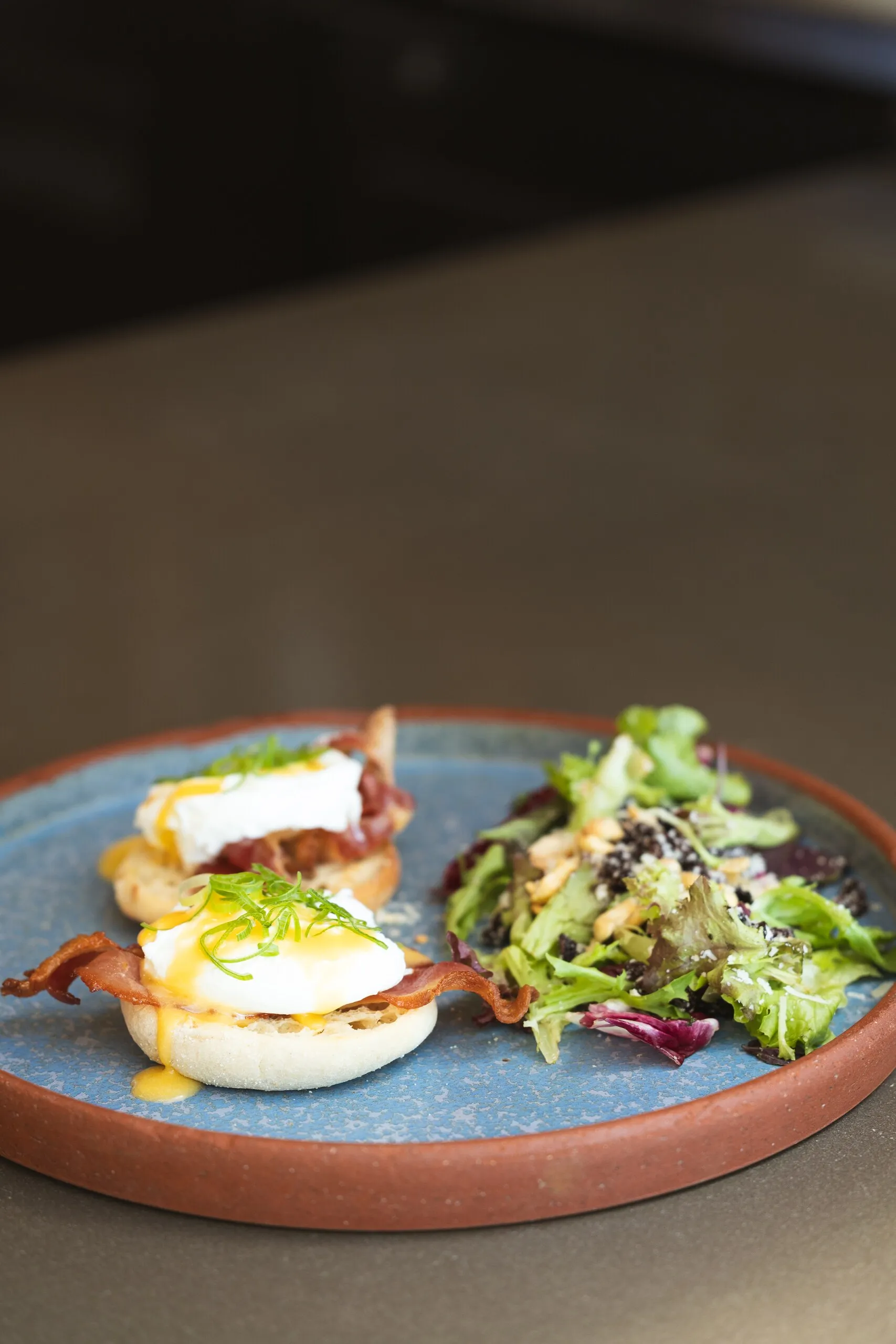 Eggs Benedict with salad served at Manzu